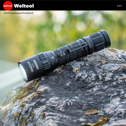 Weltool T17 flashlight on a rock with Weltool branding