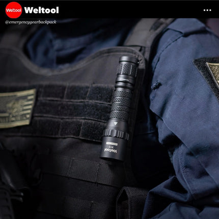 Weltool 17  flashlight attached to a tactical vest with 'Weltool' branding.