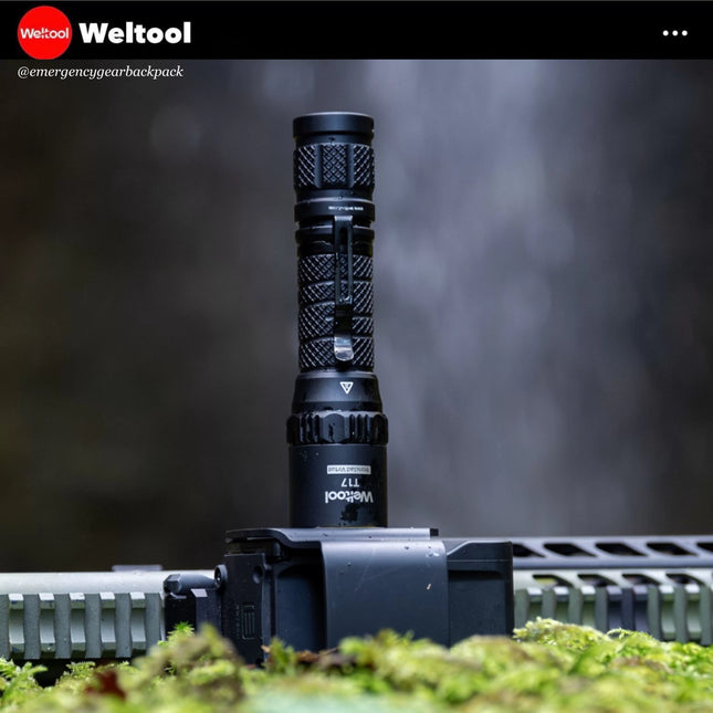 Weltool T17 flashlight with a blurred natural background, featuring the Weltool brand.