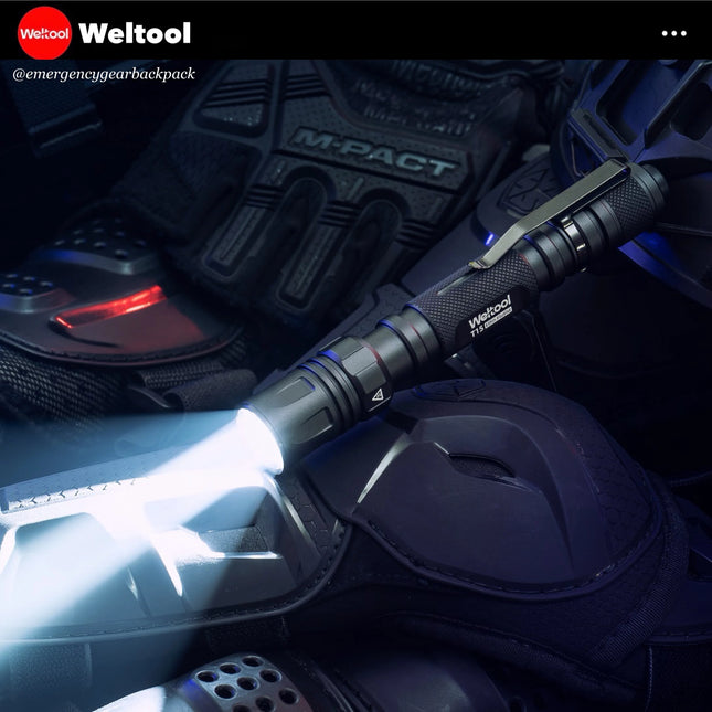 Weltool flashlight on a dark background with tactical gear