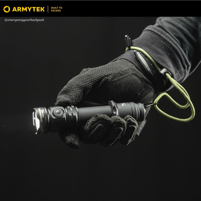 Dobermann Pro Max tactical flashlight held in a gloved hand during field operation