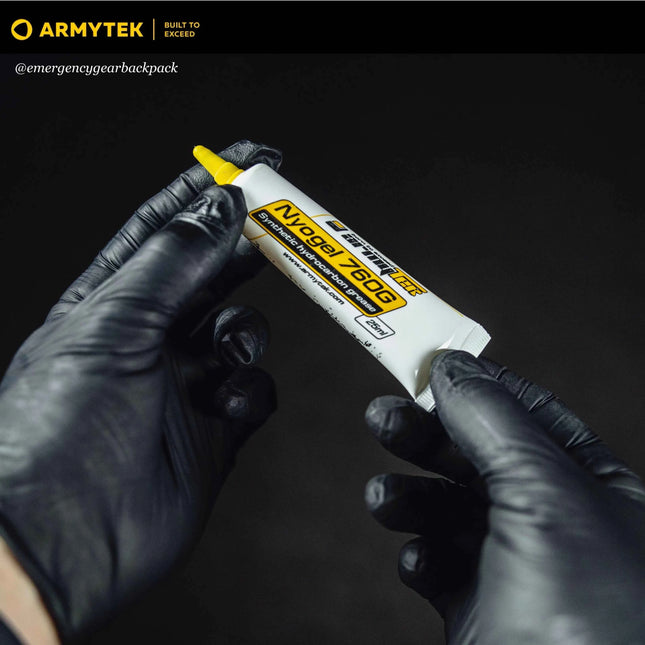 Armytek NyoGel 760G 10 ml grease tube held in gloved hands for flashlight maintenance