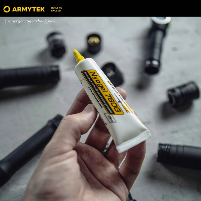 Armytek NyoGel 760G grease tube shown in hand with flashlight parts in background