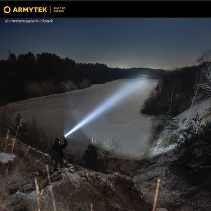 Armytek Barracuda Pro Max searchlight illuminating wide outdoor area during night search
