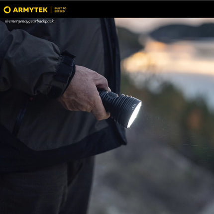 Armytek Barracuda Pro Max long range searchlight illuminating forest path at night
