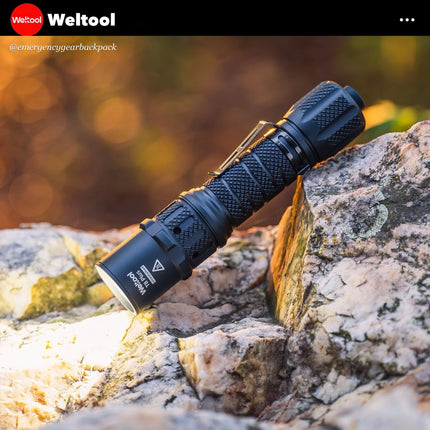 Showcase Weltool T8Plus  flashlight on a rock with Weltool branding